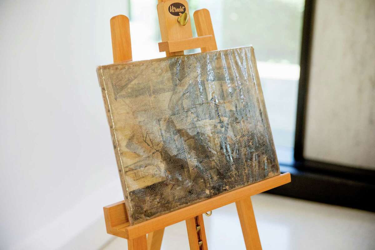 Pablo Picasso's "La Coiffeuse," seen in a protective plastic cover, is displayed at the French Embassy in Washington, Thursday, Aug. 13, 2015. The U.S. Immigration and Customs Enforcement returned the stolen painting, valued at $15 million, that was stolen in 1998 and was seized in December 2014. (AP Photo/Andrew Harnik)