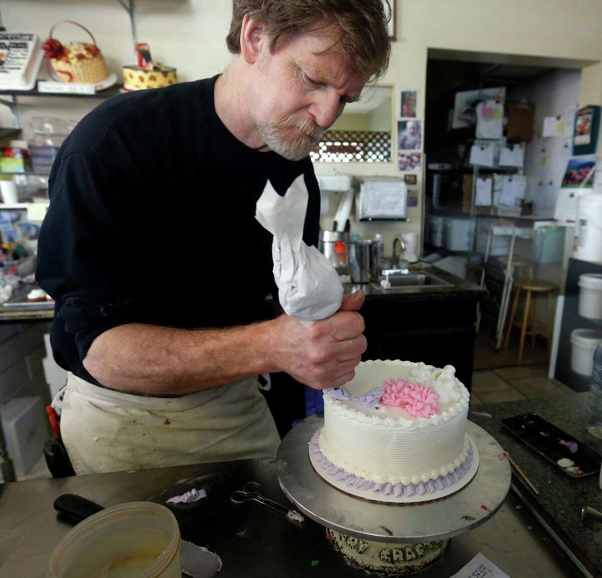 FILE - In this March 10, 2014 file photo, Masterpiece Cakeshop owner Jack Phillips decorates a cake inside his store, in Lakewood, Colo. Phillips a suburban Denver baker who wouldnât make a wedding cake for a same-sex couple cannot cite his religious beliefs in refusing them service because it would lead to discrimination, the Colorado Court of Appeals ruled Thursday, Aug. 13, 2015. (AP Photo/Brennan Linsley, File)