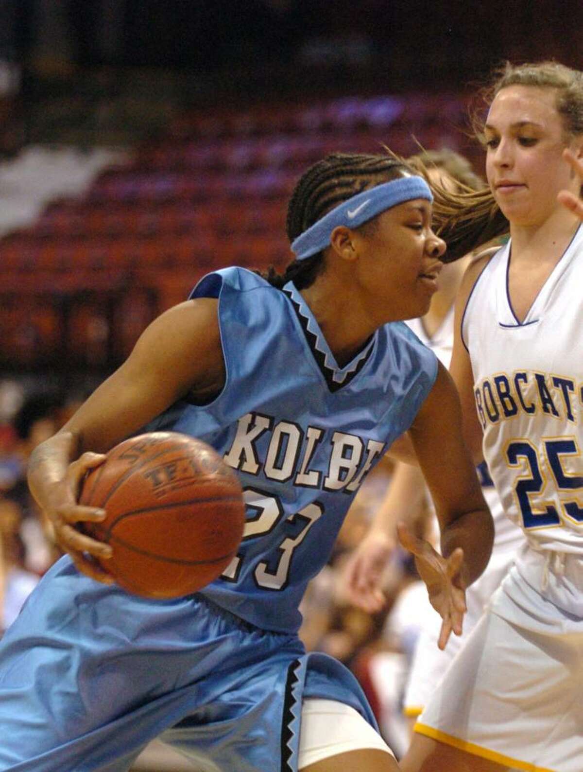 Kolbe's 23, Tiarrah Thompson trys for a basket while Brookfield's 25, Krista Melchione blocks during the championship girls basketball game at Mohegan Sun, Friday, March 19, 2010.