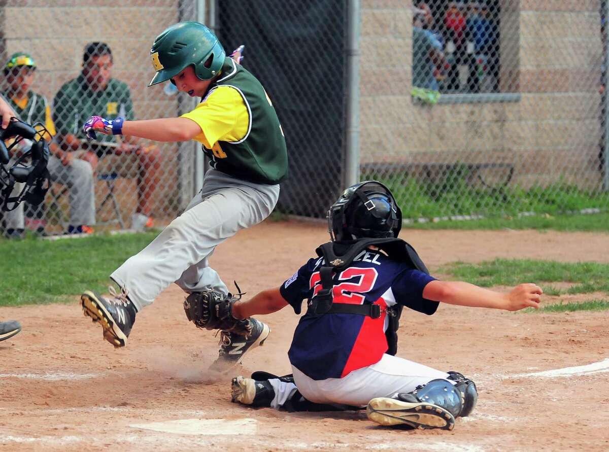 Stamford North catcher Andrew Stietzel tags out Hamden's Max Gross at home plate, during little league tournament action at Scalzi Park in Stamford, Conn., on Friday July 24, 2015.