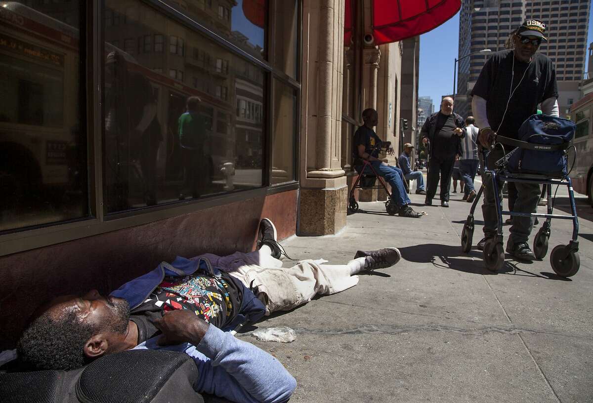 Andre Pierre Thurston sleeps outside the Glide Memorial Church, Friday, Aug. 14, 2015, in San Francisco, Calif.