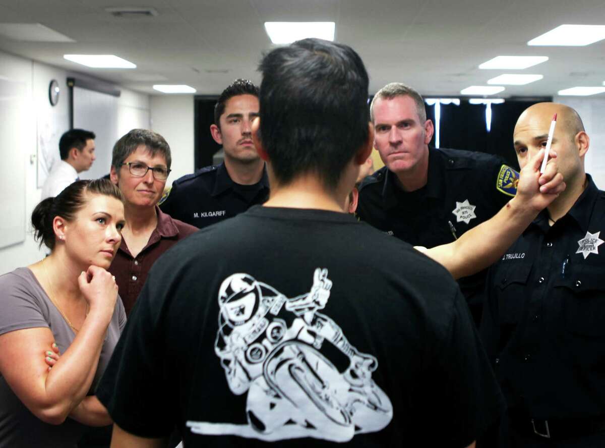 Officers watch as a horizontal gaze test is conducted on Kevin Lee, who voluntarily got intoxicated as part of the S.F. Police Department’s wet lab class to teach officers to recognize when a person they are questioning is drunk.