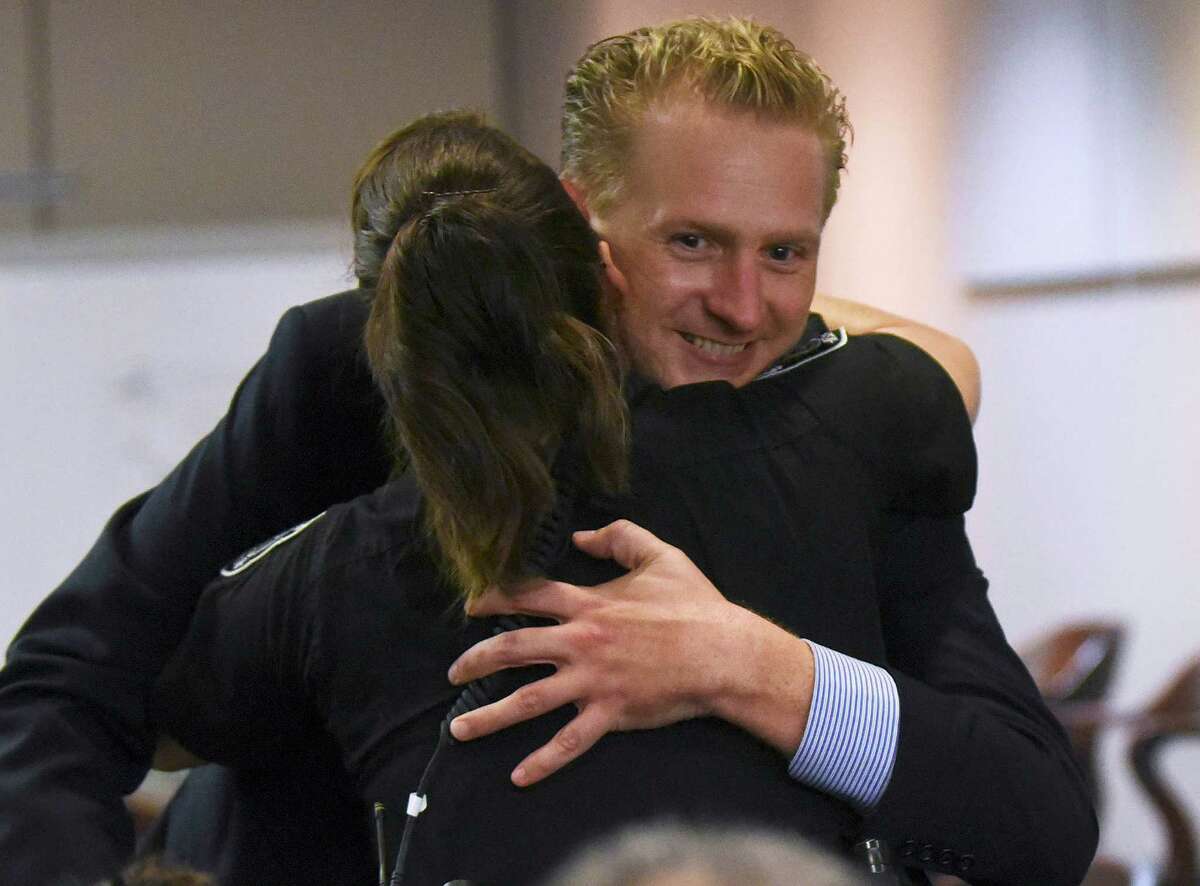 Prosecutor Jason Goss is hugged by Selma Police Officer Tiffany Kierum, who was shot in the face by Jessie Hernandez Jr., after Hernandez was sentenced to life in prison on Friday, Aug. 14, 2015.