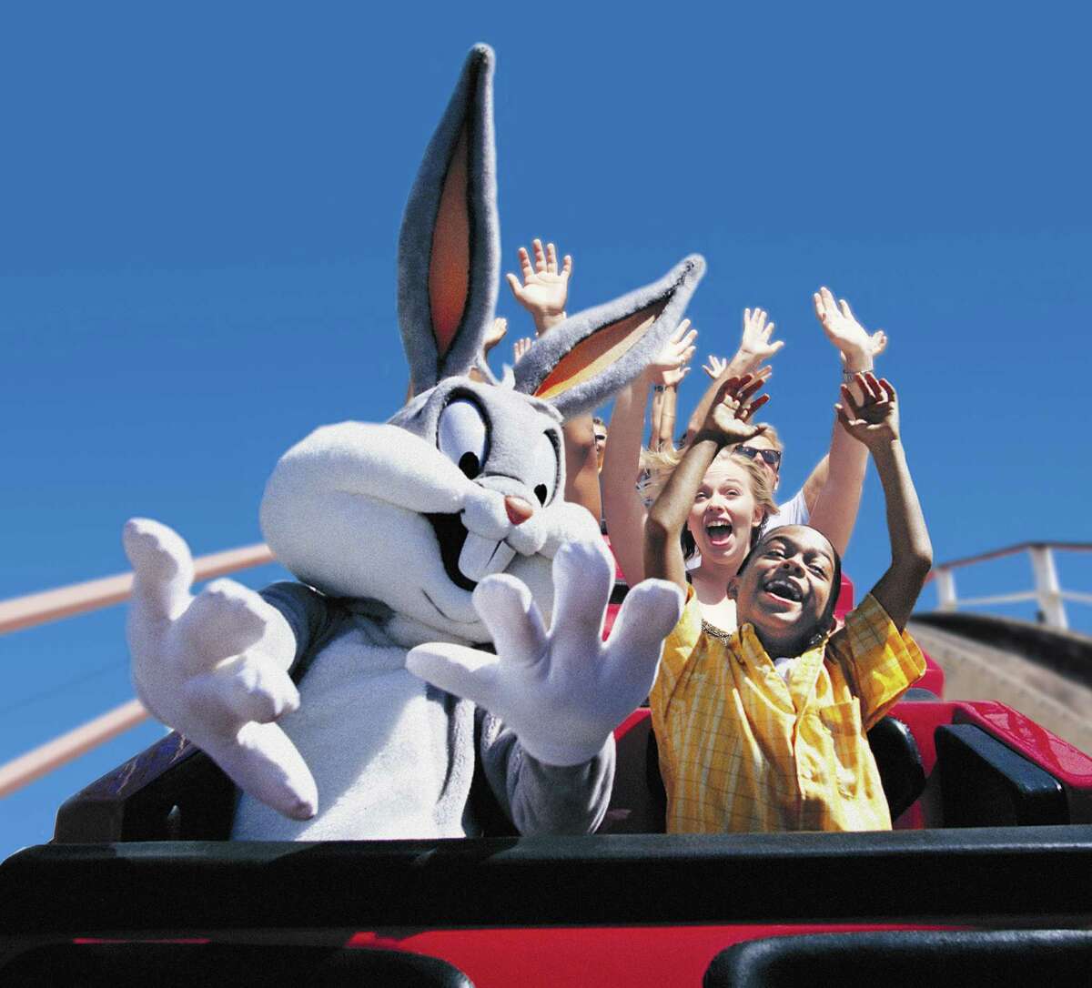 Bugs Bunny rides a rollercoaster with kids at Six Flags Fiesta Texas.