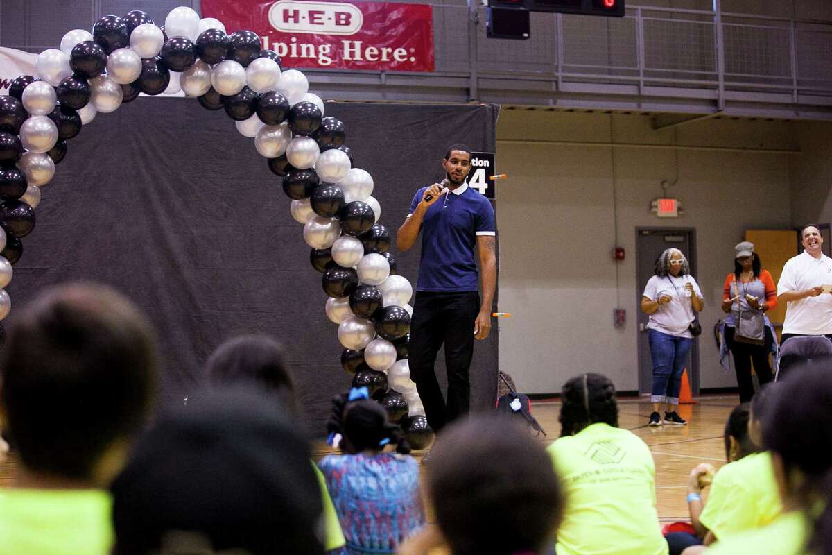 Spurs forward LaMarcus Aldridge talks to kids about the importance of education during this year's back-to-school bash, hosted by LaMarcus Aldridge and H-E-B held for 200 students from 3rd Ð 5th grades and their families on Sat. Aug. 15, 2015 at the George Gervin Academy. Students received a backpack filled with a year?•s worth of school supplies.