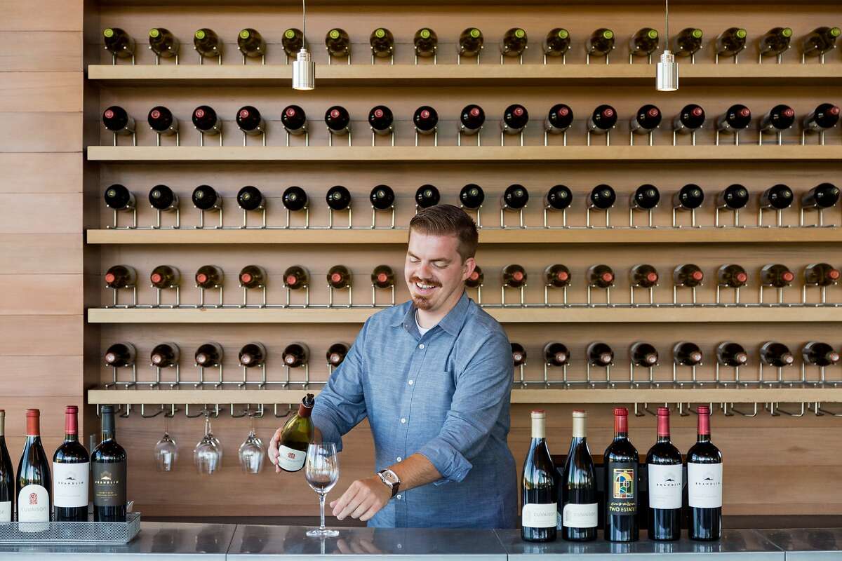 Ethan Holbrook pours wines at the Cuvaison Estate Wines tasting room in Carneros, Calif., Thursday, August 13, 2015.