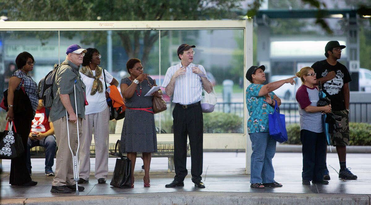 Metro riders wait for their bus at the Texas Medical Center Transit Center on Monday morning. Metro introduced a new route system for passengers starting Sunday.