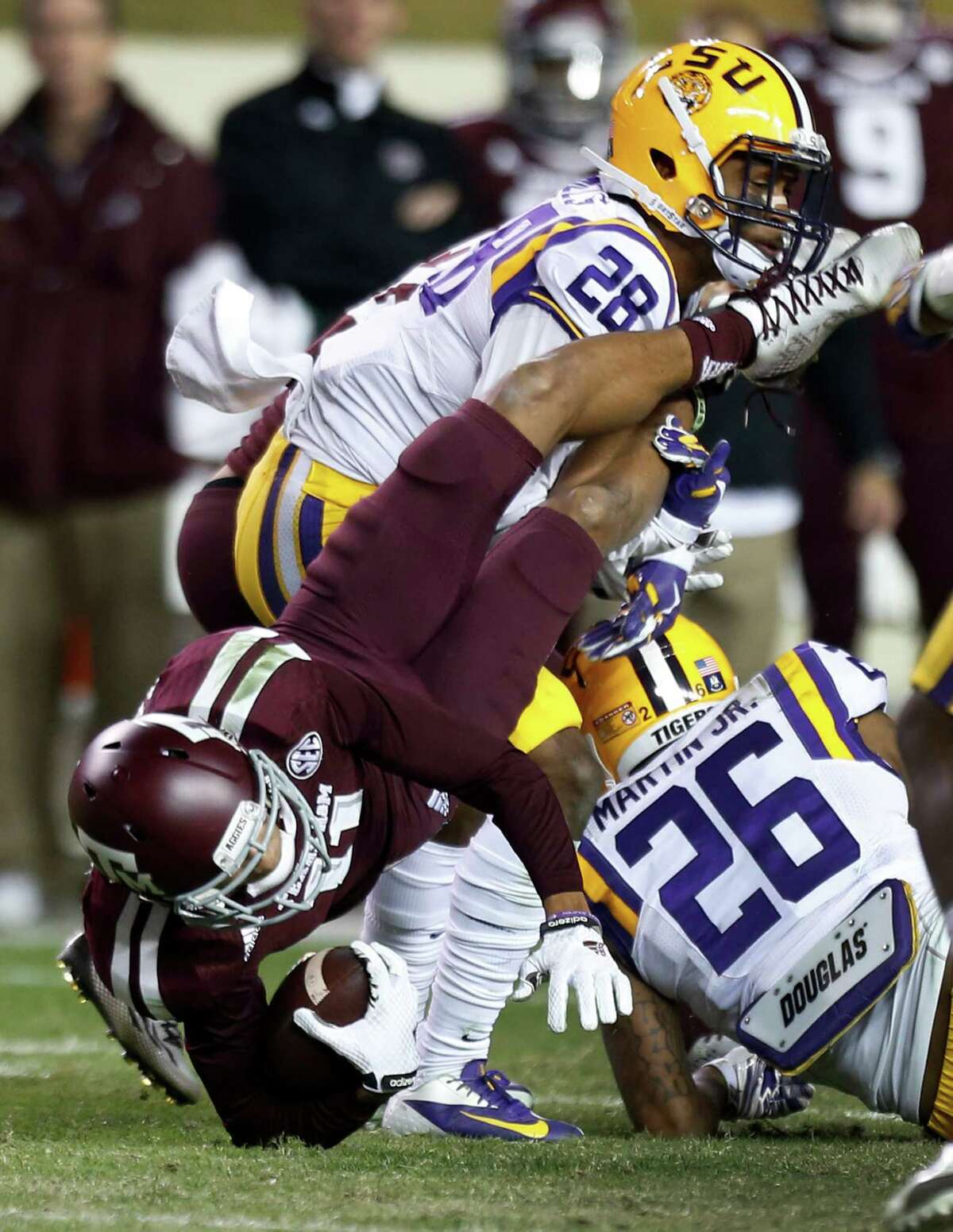 Texas A&M wide receiver Josh Reynolds (11) is tackled by LSU safety Jalen Mills (28) during the fourth quarter of an NCAA college football game at Kyle Field Thursday, Nov. 27, 2014, in College Station.