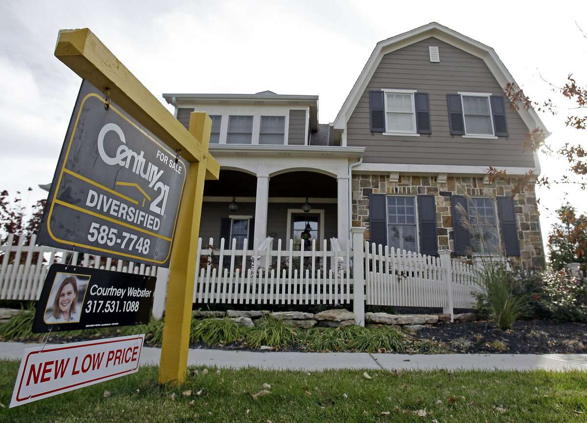 FILE - This Oct. 20, 2009, file photo, shows a home with a reduced price for sale in Carmel, Ind., neighborhood. Short of cash and unsettled in their careers, young Americans are waiting longer than ever to buy their first homes. The delay reflects a trend that cuts to the heart of the financial challenges facing millennials: Renters are struggling to save for down payments. (AP Photo/Michael Conroy, File)