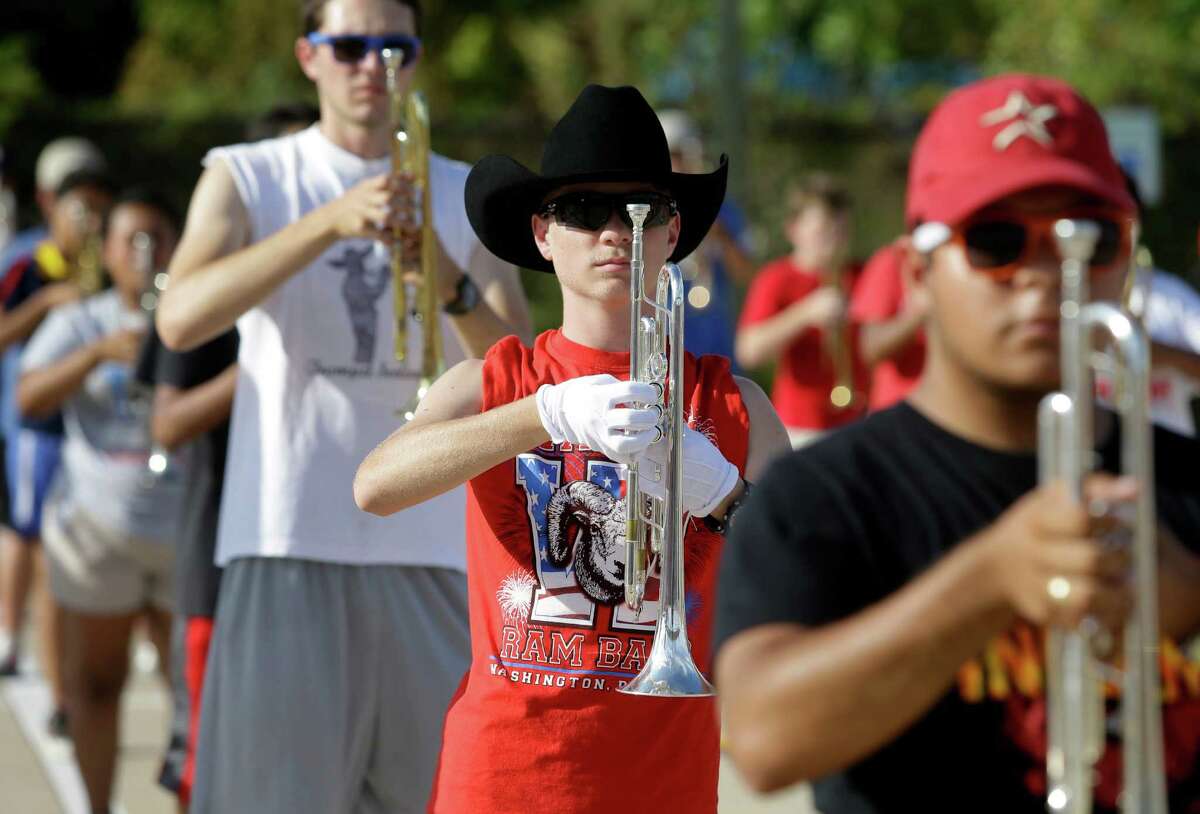Waltrip High School marching band musicians prac- tice Tuesday﻿. For the first time, all HISD band mem- bers need a physical exam to march at games this year.