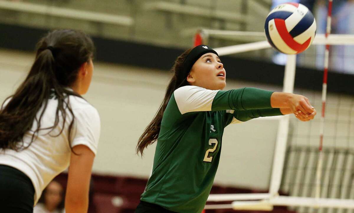 Reagan’s Tori Hinojosa sets up a play against O’Connor in a non-district volleyball game at Littleton Gym on Tuesday, Aug. 18, 2015.