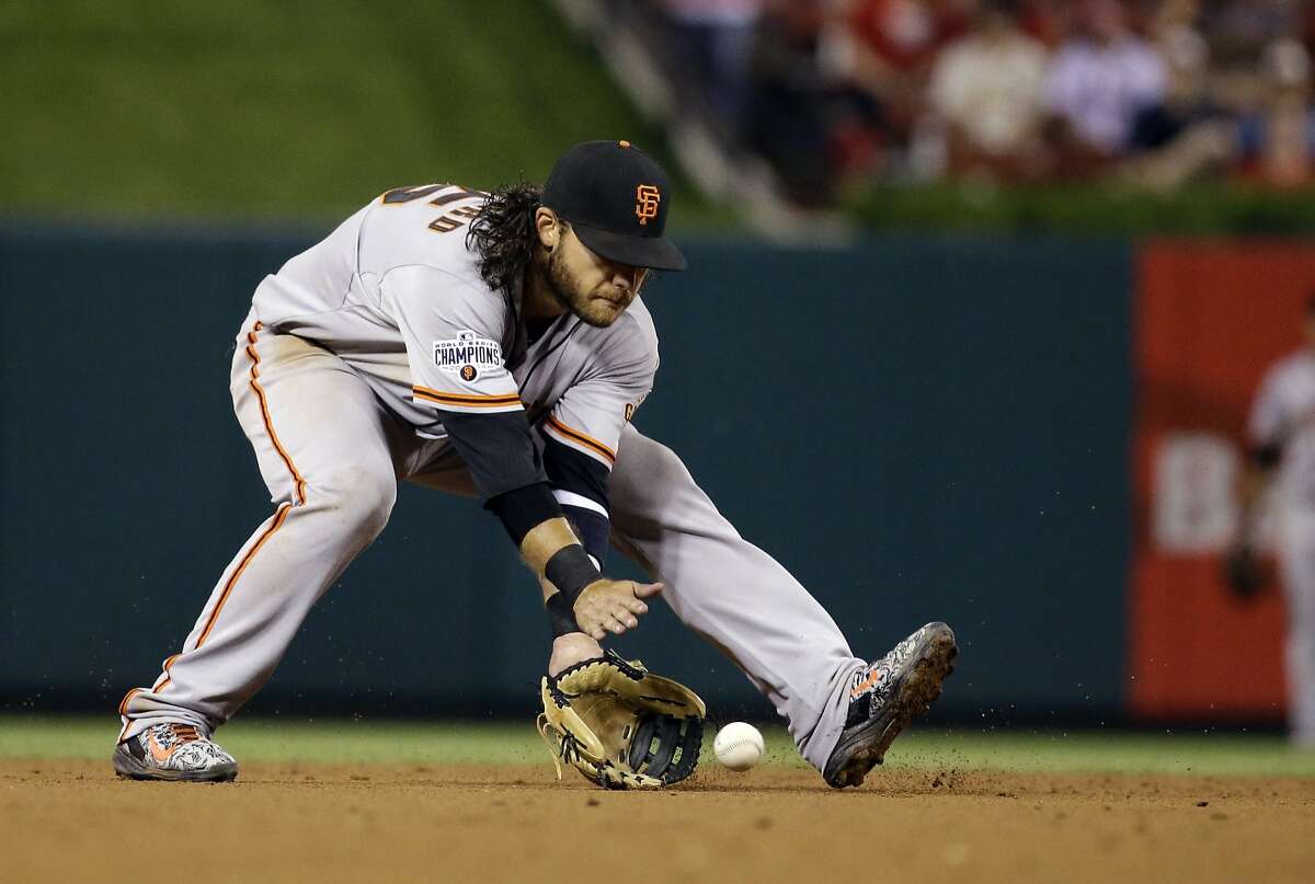San Francisco Giants shortstop Brandon Crawford handles a grounder hit by St. Louis Cardinals' Stephen Piscotty during sixth inning of a baseball game Tuesday, Aug. 18, 2015, in St. Louis. (AP Photo/Jeff Roberson)