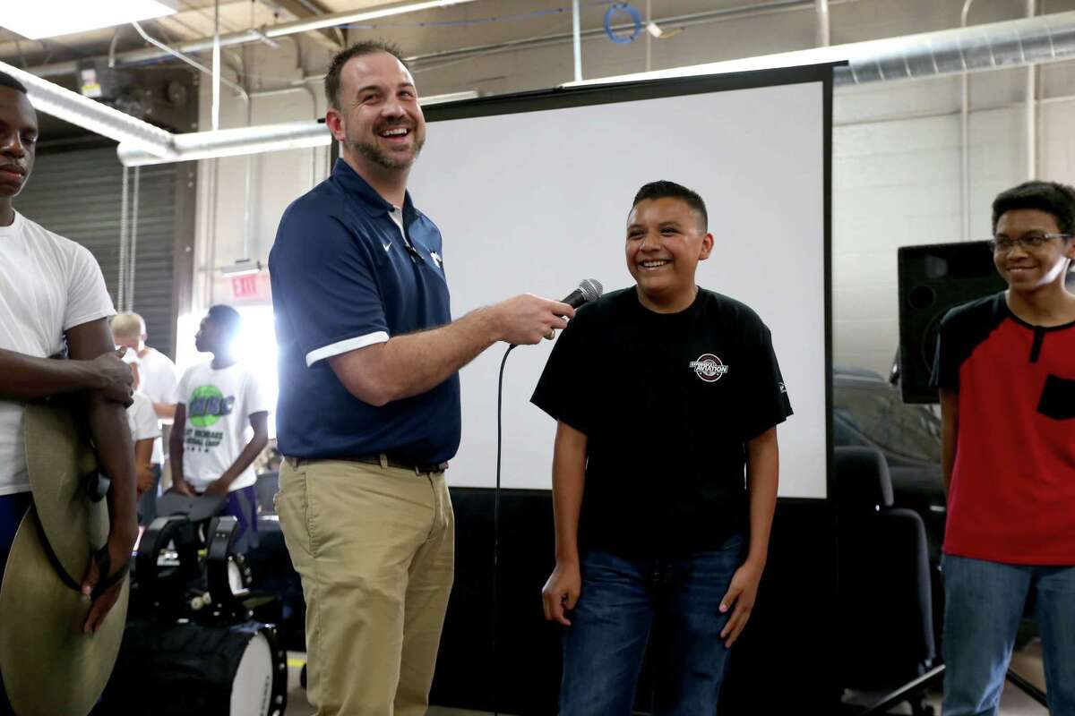 Creighton Jaster, assistant principal and supervisor of summer program, and incoming freshman Ethan Portillo, 14, answer questions of family and Lamar Consolidated Independent School District officials at the unveiling of a Factory Five 818 kit car built by thirty-one incoming freshman, who participated in the Build and Soar summer program, at Lamar Consolidated High School Tuesday, Aug. 18, 2015, in Rosenberg, Texas. The car was built from parts donated from a 2002 Subaru WRX.
