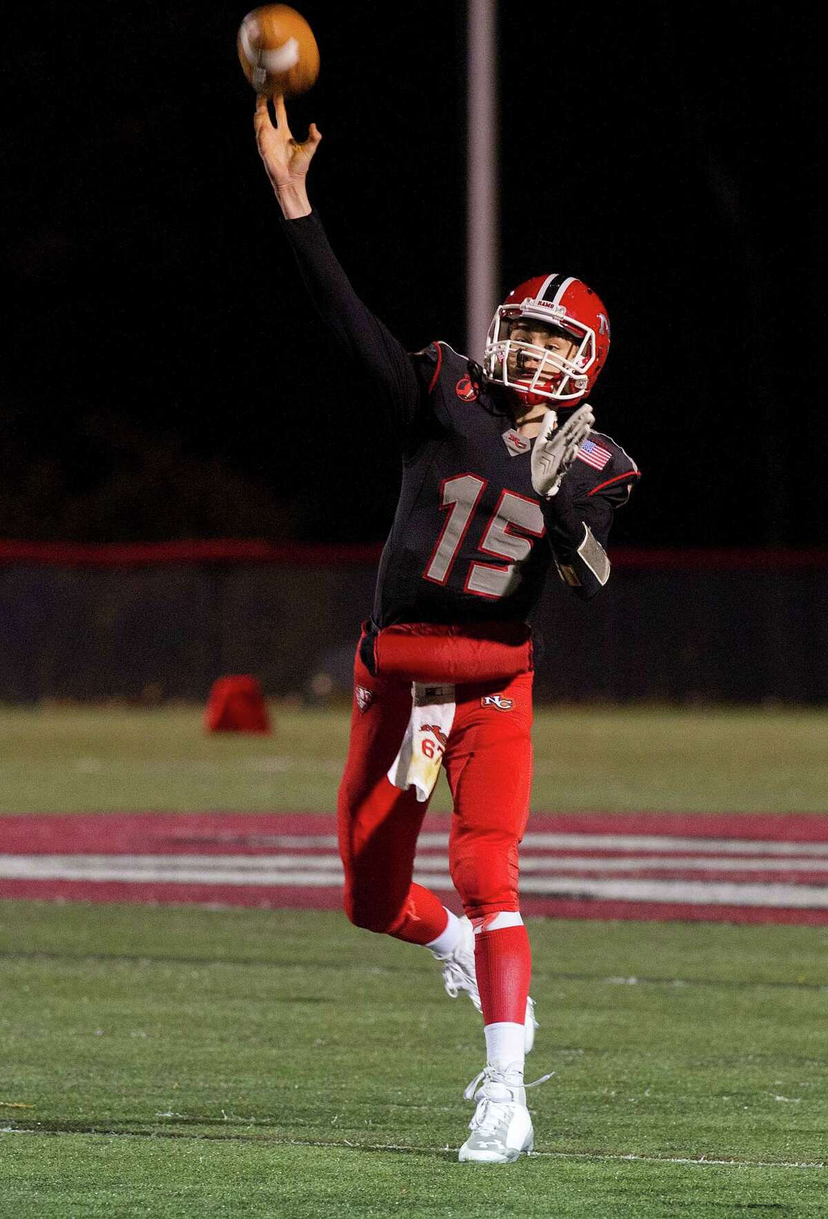 New Canaan's Michael Collins throws a pass during Friday's football game against Wilton at New Canaan High School on November 7, 2014.