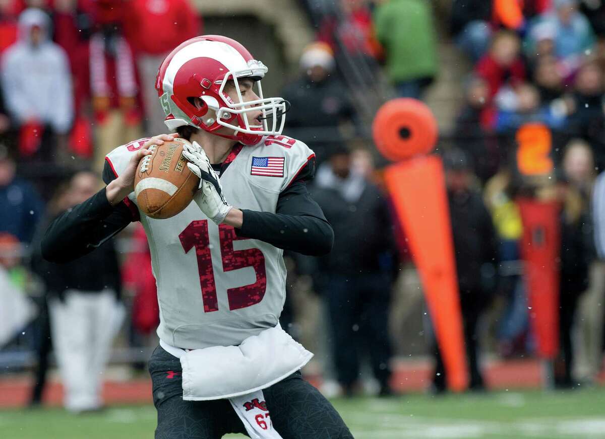 New Canaan's Michael Collins throws a pass during the FCIAC championship game between New Canaan High School and Darien High School in Stamford, Conn., on Thanksgiving Day, Thursday, November 27, 2014.
