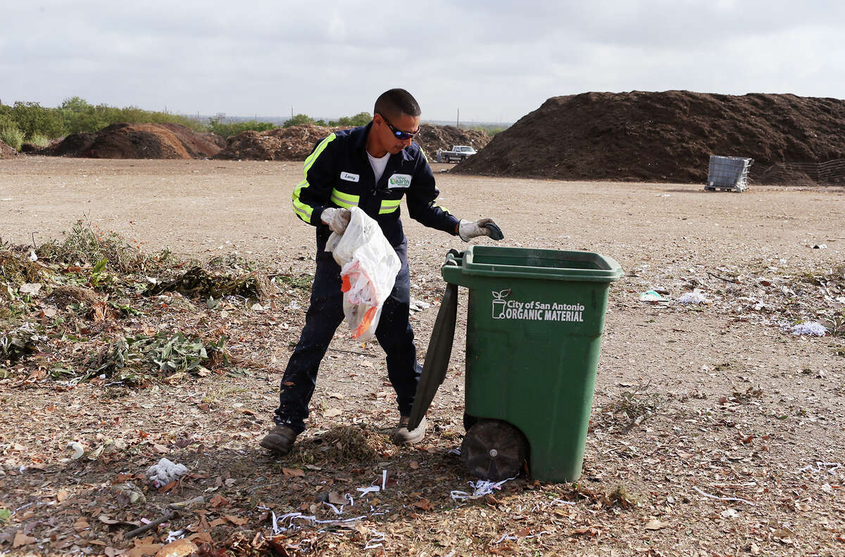 Organic Monitor Larry Rosalez sorts through organic material picked up by the City of San Antonio Solid Waste Department at the New Earth Soils and Compost facility at 7800 East IH-10, Tuesday, August 18, 2015. Rosalez takes out inorganics, such as plastics and bottles, from the material that is turned into compost. The city is offering its residents lower rates for garbage service by letting them recycle more of their waste for a lower bill under a program called, "Pay as You Throw". Residents have the option of cutting their solid waste collection fee by choosing a smaller garbage bin and recycling more items.