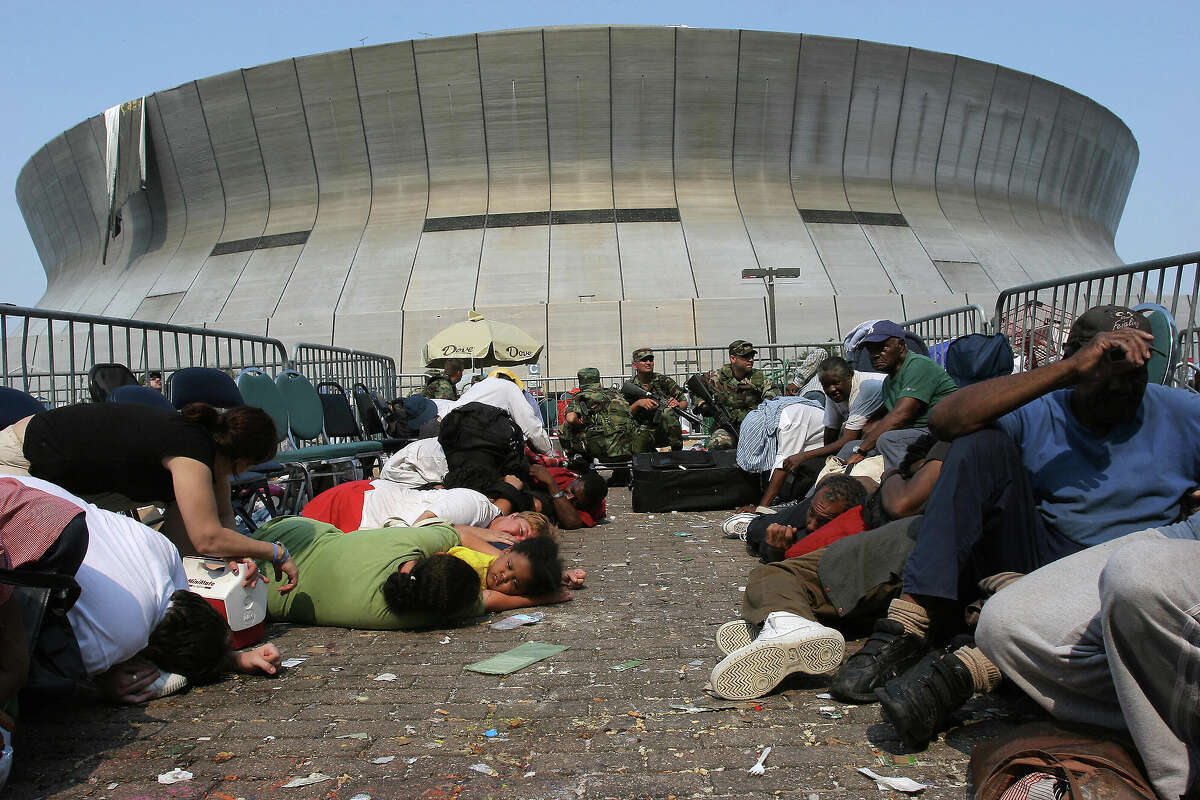 September 3, 2005 file photo shows people waiting to be evacuated from the Superdome in New Orleans taking cover after the National Guard reported shots being fired outside the arena, six days after Hurricane Katrina devastated the southern port city.