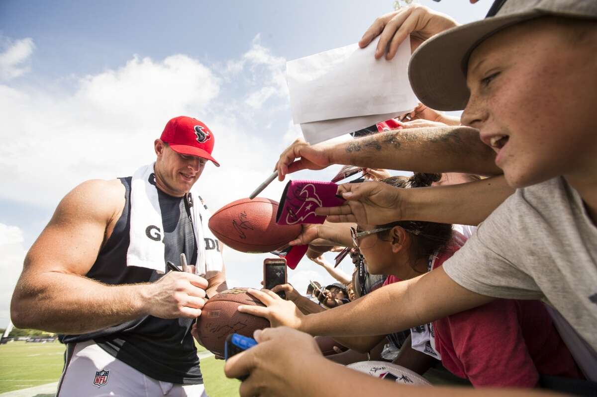 J.J. Watt signs autographs during Texans training camp on Wednesday, Aug. 19, 2015. (For yet more painfully cute photos of Watt with kids, scroll through the slideshow.)