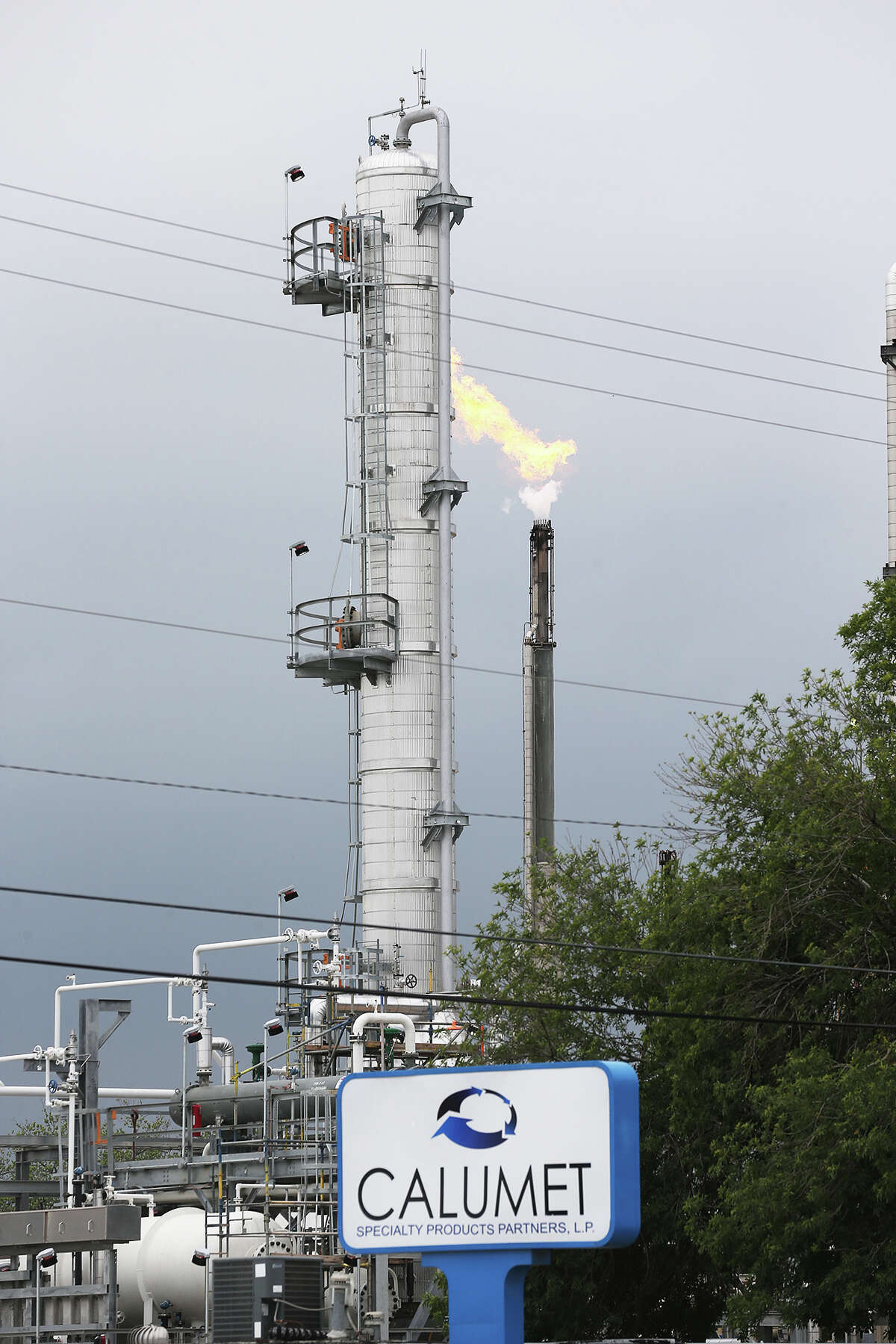 A flare from the Calumet Specialty Products Partners plant is seen near the Mission Reach of the San Antonio River in April 2014 when a second jet fuel spill happened.