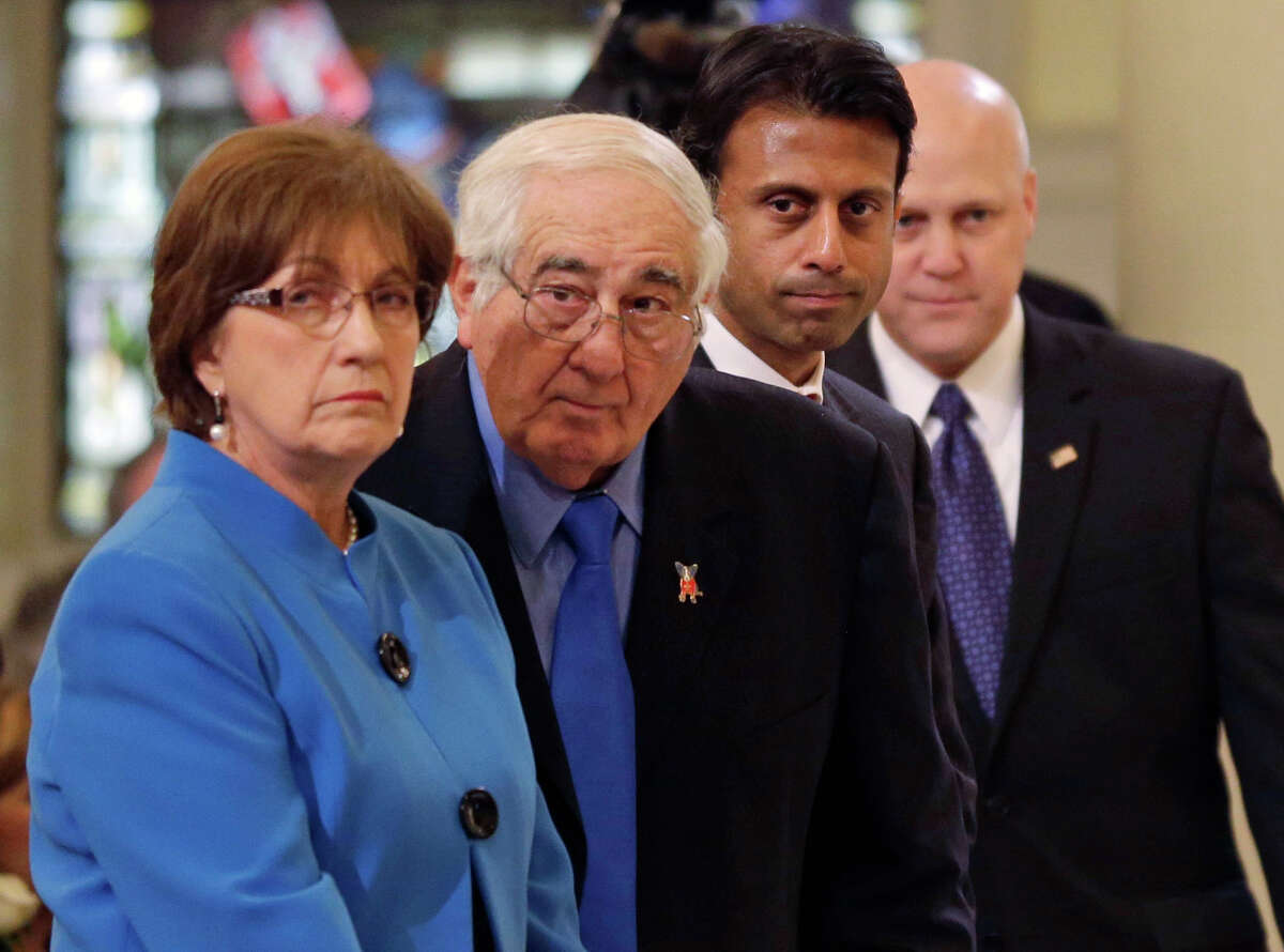 ADVANCE FOR USE FRIDAY, AUG. 21, 2015 AND THEREAFTER - FILE - In this Thursday, Dec. 19, 2013 file photo, from left, former Louisiana Gov. Kathleen Blanco; her husband, Raymond Blanco; Gov. Bobby Jindal and New Orleans Mayor Mitch Landrieu attend a funeral Mass for artist George Rodrigue at the St. Louis Cathedral in New Orleans. The only woman elected governor of the state was named a Louisiana Legend in May by Friends of Louisiana Public Broadcasting for, among other things, "overcoming extraordinary early resistance" and getting more than $29 billion in federal recovery money for Louisiana, and for leaving the state with a surplus of nearly $2 billion. She nursed her husband after a fall that threatened his life in 2010, and was diagnosed with cancer in her left eye a year later. She says her vision is now fine, and her prayers against cancer "have been answered."