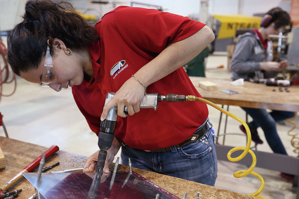 Cristyn Gomez, 18, works on part of an airplane wing during a class at the Alamo Academies for IT and aerospace engineering training, Thursday, April 30, 2015. The class is part of Alamo CollegesÍ Workforce Center for Excellence and is located at St. Philip's College campus on Quintana Road. The program won a national Bellwether Award for innovative community college programs. Gomez is a senior at East Central High School.