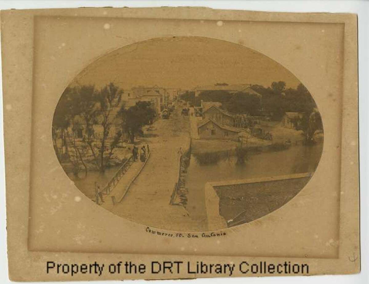 "Commerce St., San Antonio," circa 1850s From the DRT: "This view of the old Commerce Street bridge is perhaps the most picturesque of the series... The scene is a view across the bridge from the east side of the river -- from which point today one sees the cylindrical Clifford Building on the north side of the street just west of the bridge, and Schilo's delicatessen on the south side of the street."