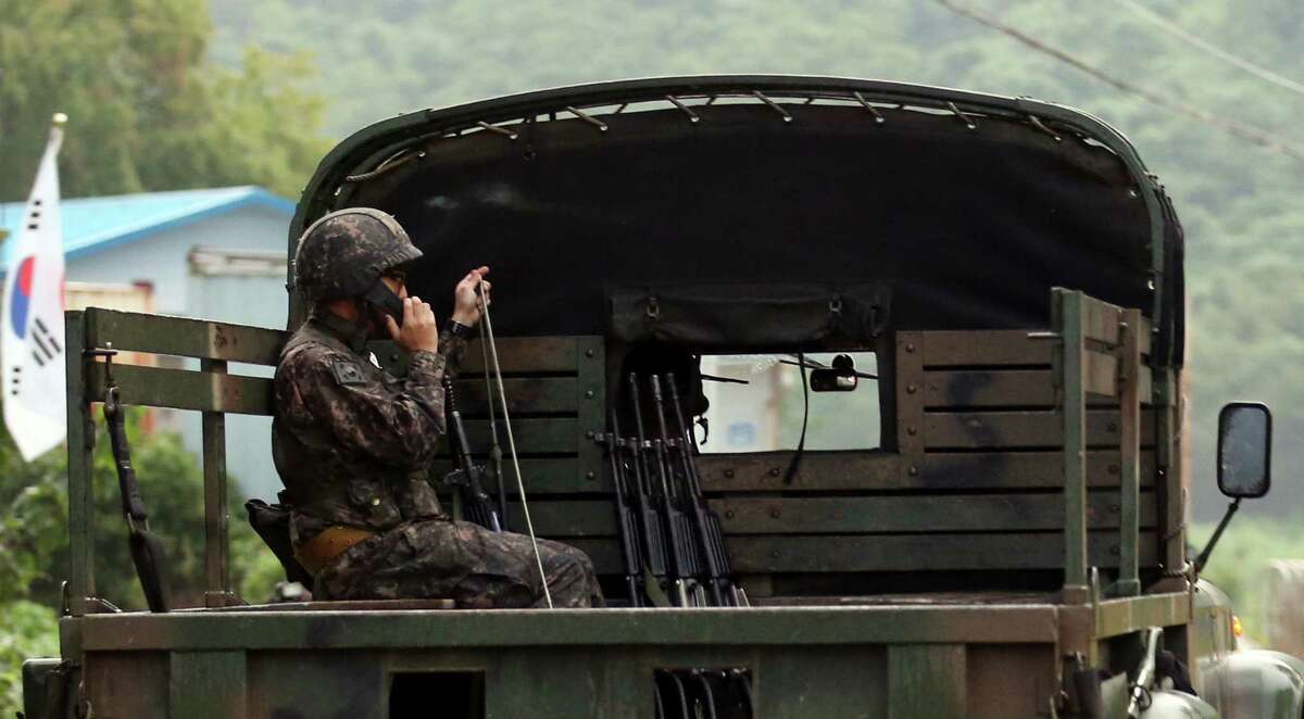 A South Korean soldier uses a radio on a military vehicle at the South Korean border town of Yeoncheon, South Korea, Thursday, Aug. 20, 2015. South Korea's military fired dozens of shells Thursday at rival North Korea after the North lobbed a single artillery round at the border town, the South's Defense ministry said. (Hong Hae-in/Yonhap via AP) KOREA OUT