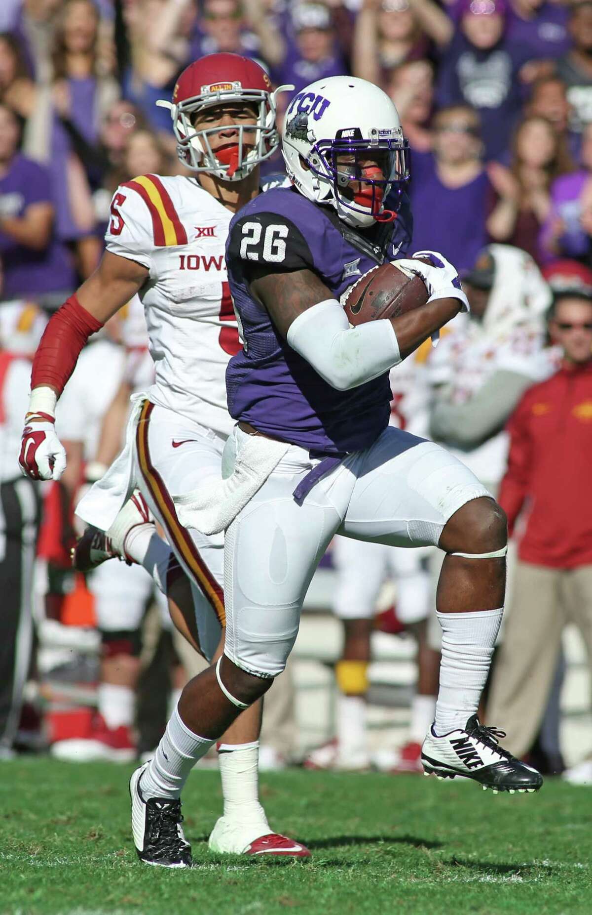TCU safety Derrick Kindred (26) returns an interception for a touchdown during the third quarter of an NCAA college football game against Iowa State at Amon G. Carter Stadium, Saturday, Dec. 6, 2014, in Fort Worth.