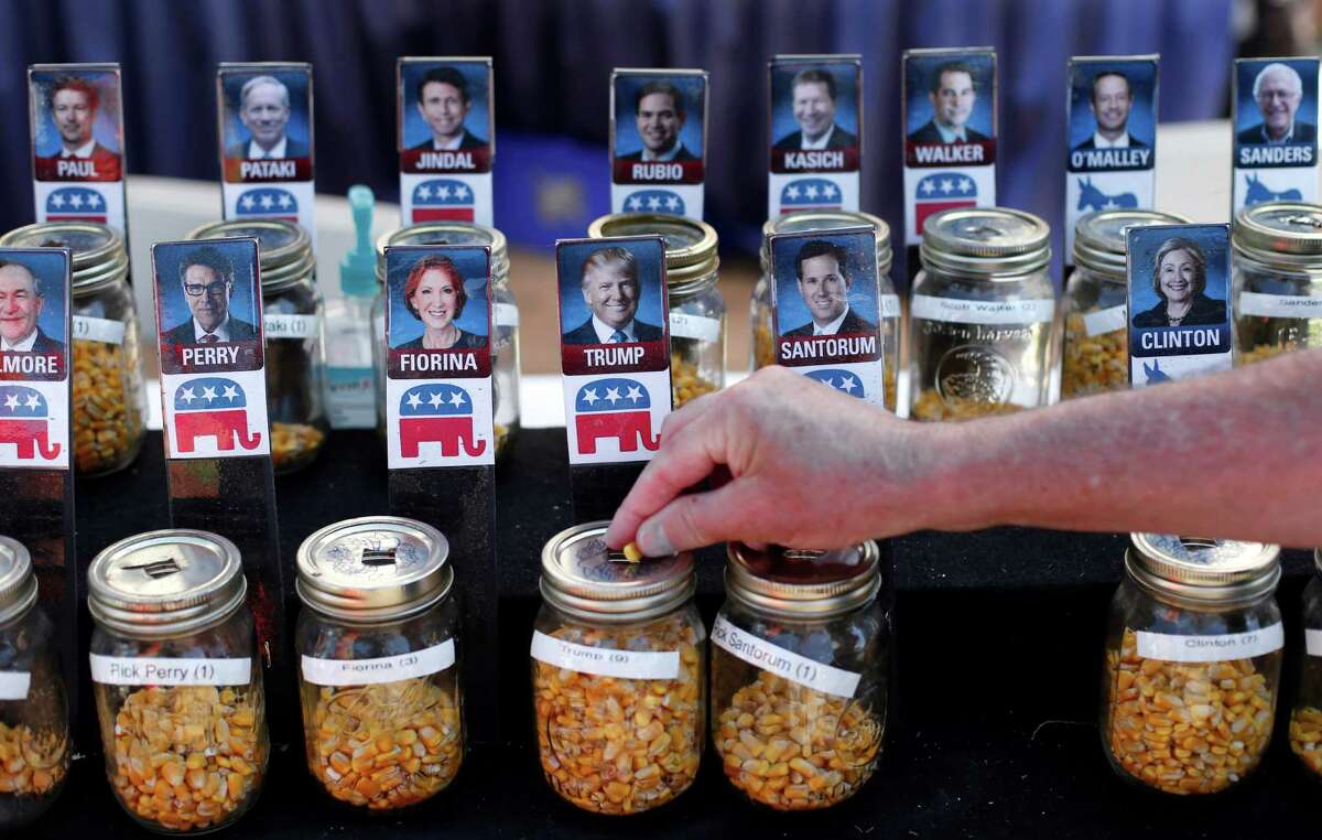 A visitor casts their vote with a kernel of corn for presidential candidate Donald Trump in a straw poll at the Iowa State Fair, Thursday, Aug. 20, 2015, in Des Moines, Iowa. (AP Photo/Paul Sancya)