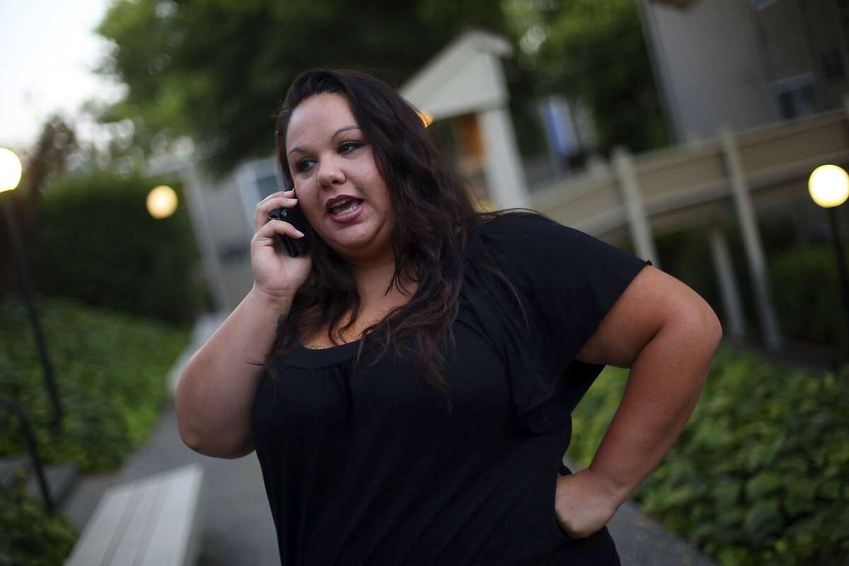 Calico Rose, who stores her phone in her bra, on the phone with her children in Vallejo, Calif., July 7, 2015. A Berkeley measure requiring retailers to warn cellphone customers about radiation exposure is on hold pending a lawsuit from the wireless industry. â€?“It would probably take substantial use to cause cancer,â€ Rose said. (Jim Wilson/The New York Times)