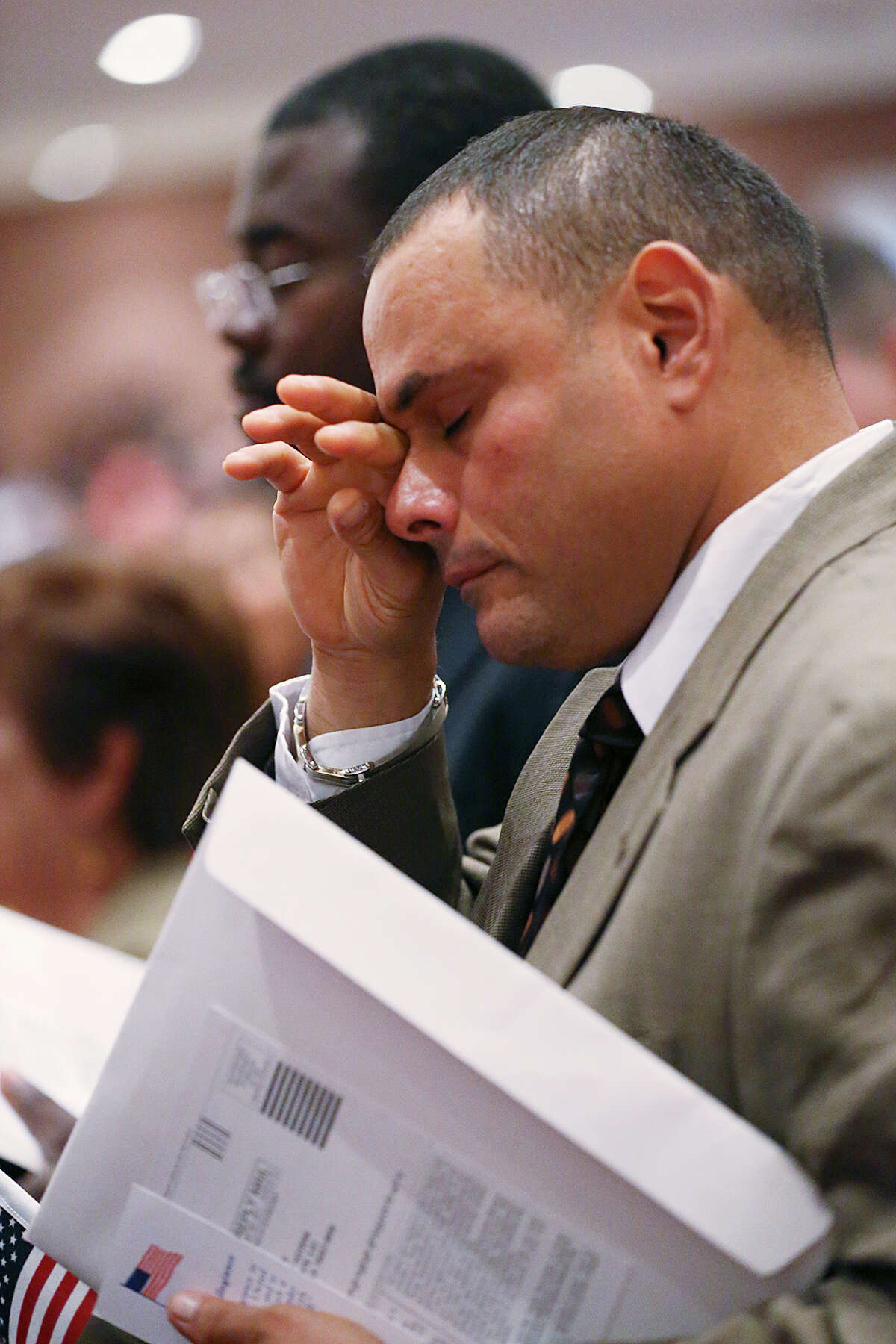 Francisco Moreno, 48, of Venezuela, reacts during one of two naturalization ceremonies held by the U.S. Citizens and Immigration Services at the Edgewood Theatre of Performing Arts for a naturalization ceremony, Thursday, August 20, 2015. A total of 994 new citizens took the Oath of Allegiance given U.S. Magistrate Judge John W. Primomo. U.S. Congressman Joaquin Castro was the main speaker at the first event.