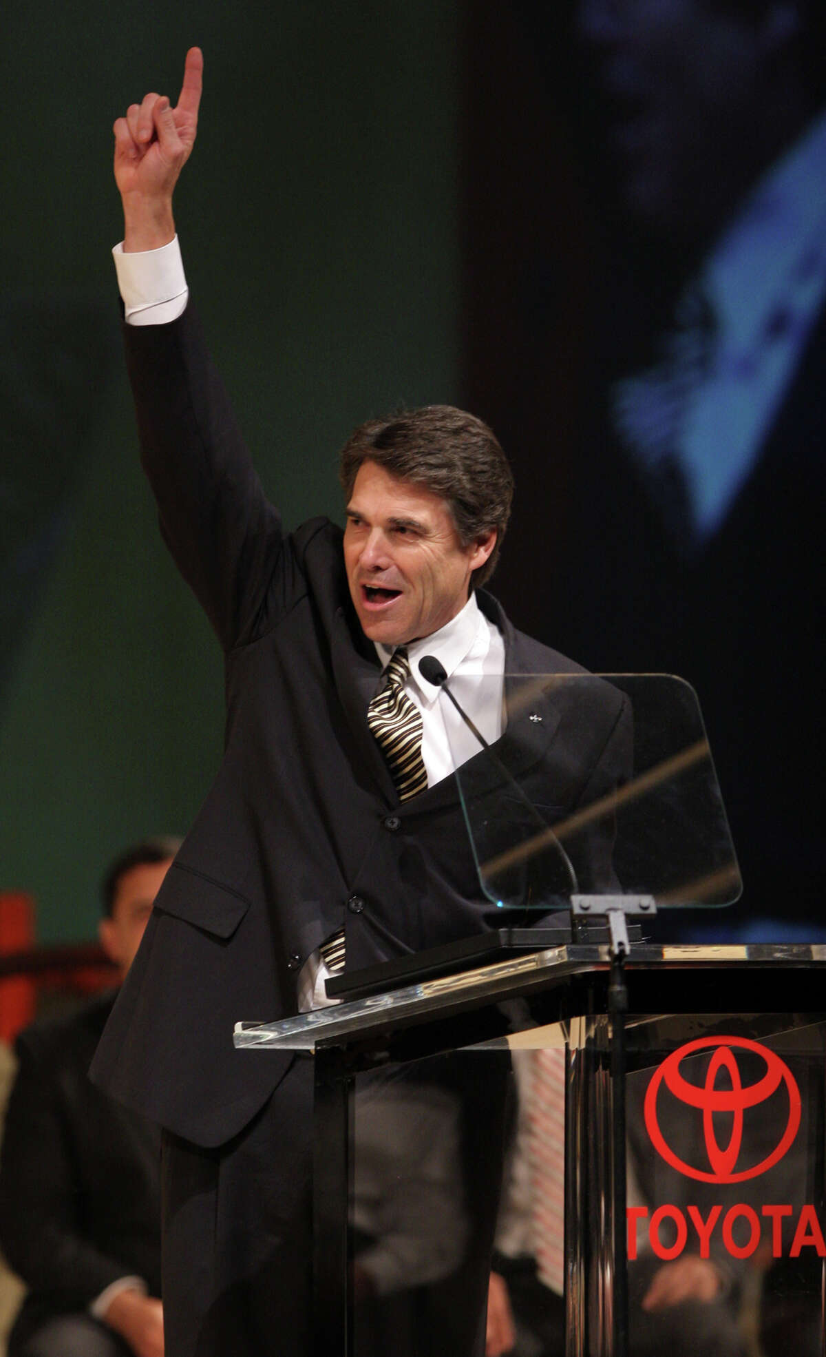 Texas Gov. Rick Perry gives the number one sign as the first Toyota Tundra truck rolls off at the New Toyota Motor Manufacturing of Texas plant in San Antonio, Nov. 17, 2006.