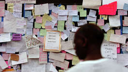 KRT US NEWS STORY SLUGGED: WEA-KATRINA KRT PHOTOGRAPH BY JIM MACMILLAN/PHILADELPHIA DAILY NEWS (September 3) HOUSTON, TX-- Messages left by evacuees in search of missing loved ones are posted inside the Astrodome in Houston, Texas Saturday, September 3, 2005.   (lde) 2005