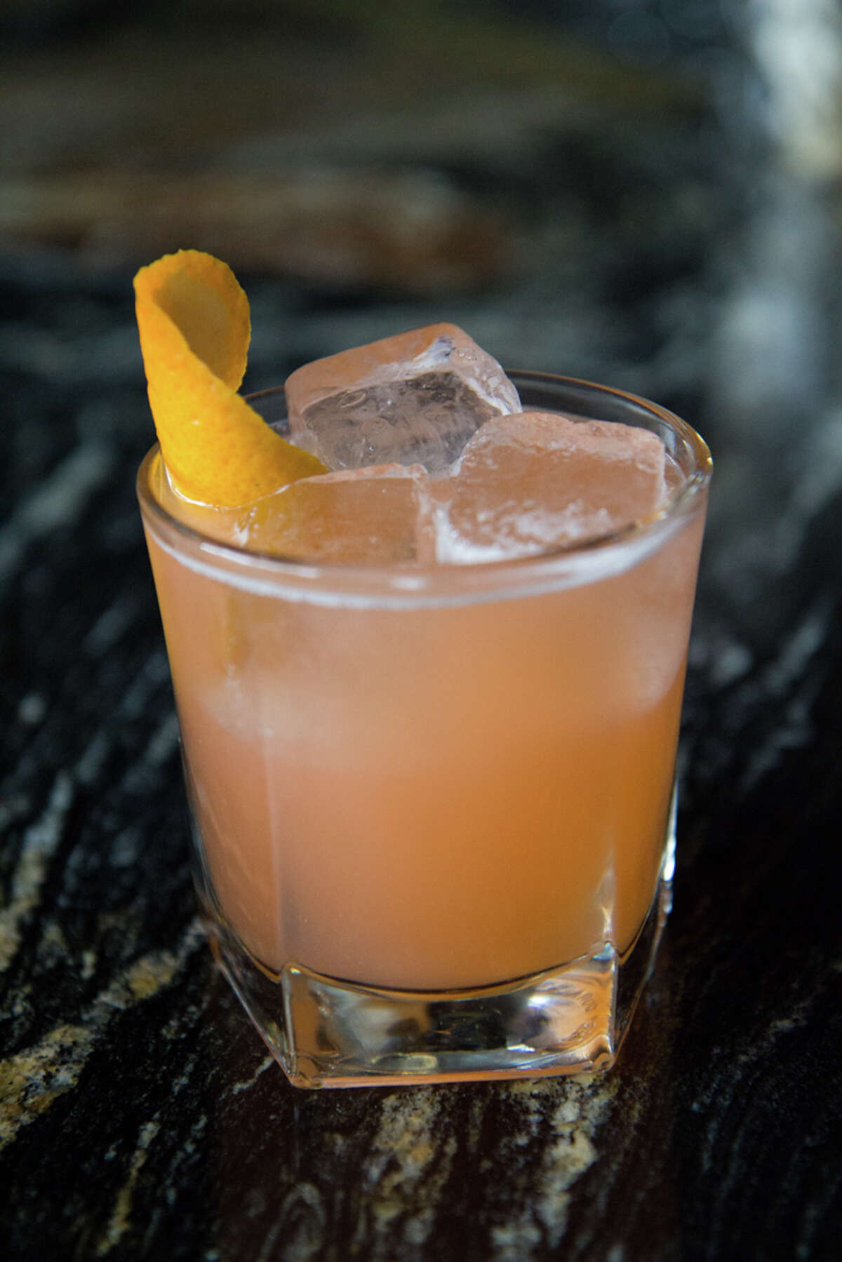 Tiki Tossback is a summer cocktail from Stone's Throw bar in Houston. It's made with vodka, coconut rum, Aperol and tiki bitters.