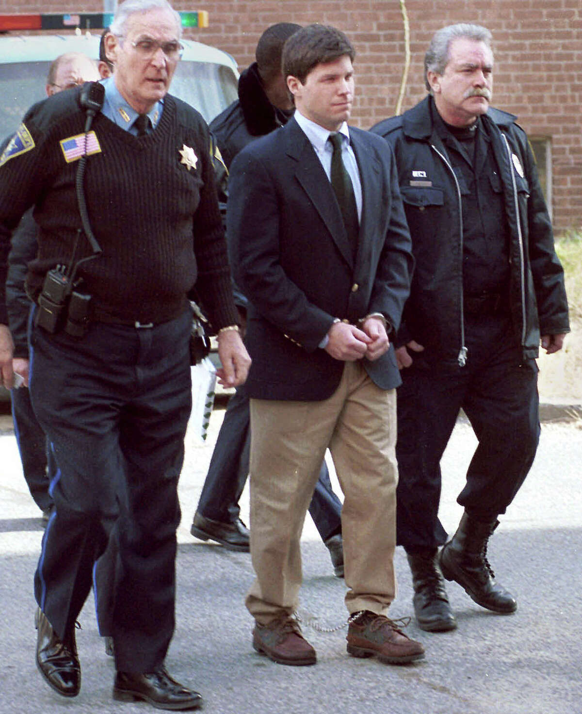 Convicted rapist Alex Kelly, center, is led out of Stamford Superior Court on Dec. 23, 1998. Kelly, who said he was a changed man who is sorry for what he has done during an unsuccesful 2005 bid for parole. But one of his victims says the former international fugitive urged the parole board to keep Kelly behind bars, saying she lived in fear while Kelly enjoyed skiing and mountain climbing in Europe.