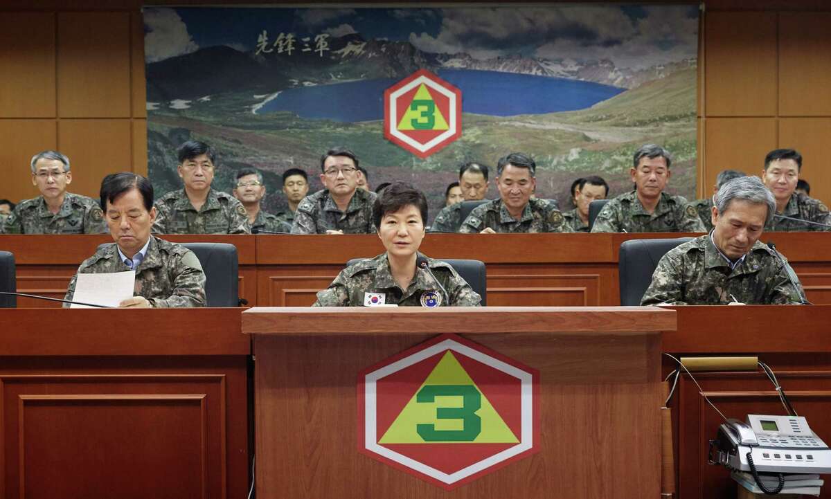 South Korean President Park Geun-hye, bottom center, presides over a security meeting to check South Korea's military readiness against North Korea's military attack at the headquarters of Third Army in Yongin, South Korea, Friday, Aug. 21, 2015. North Korean leader Kim Jong Un on Friday declared his frontline troops in a "quasi-state of war" and ordered them to prepare for battle a day after the most serious confrontation between the rivals in years. (Baek Seung-ryul/Yonhap via AP) KOREA OUT