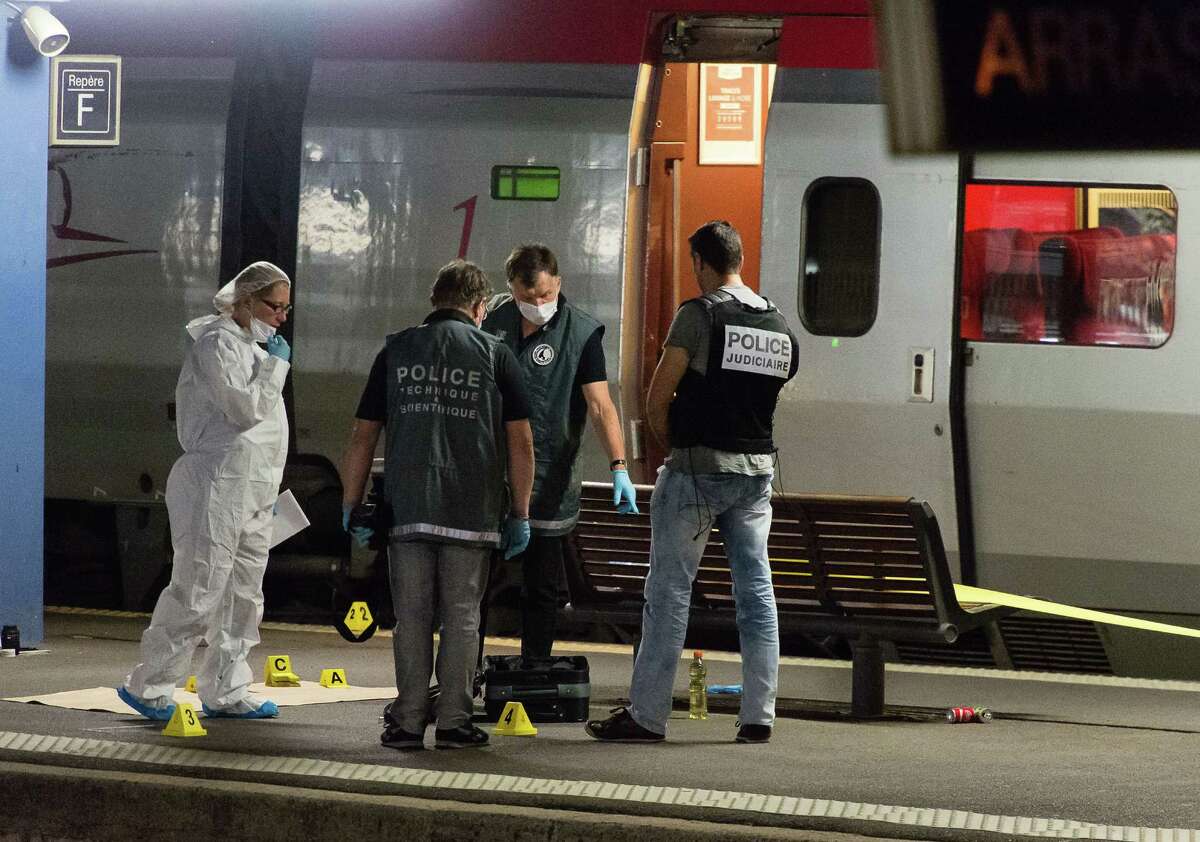 Officials﻿ investigate at Arras train station in northern France after they say a gunman fired an automatic weapon on a high-speed train traveling to Amsterdam. to Paris Friday, wounding three people before being subdued by two American passengers, officials said. French Interior Minister Bernard Cazeneuve, speaking in Arras in northern France where the suspected was detained, said one of the Americans was hospitalized with serious wounds. (AP Photo)