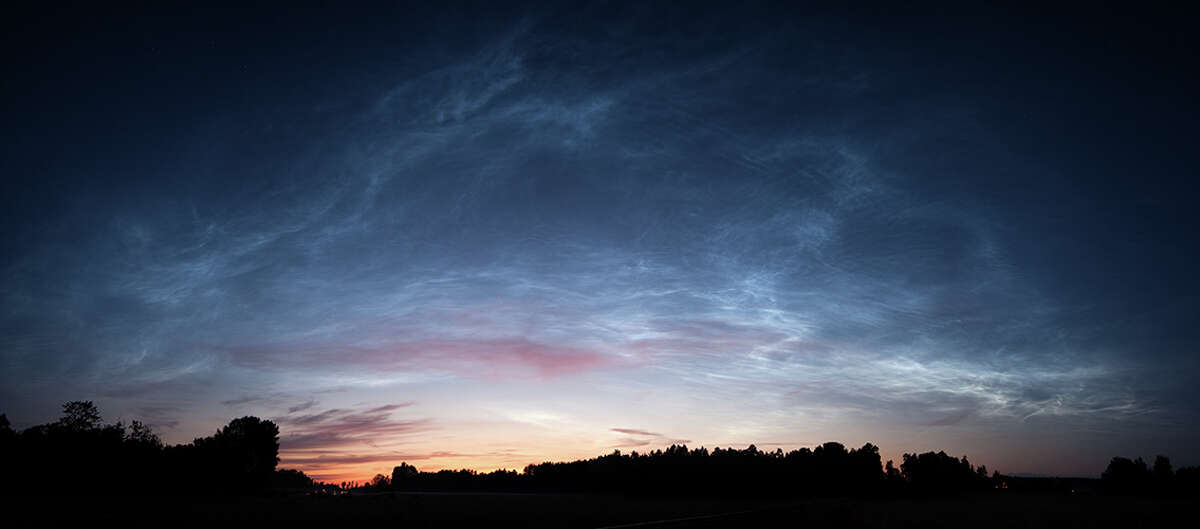 Noctilucent clouds over Källby, Sweden on Jul. 14, 2009. Noctilucent clouds glow at night in northern latitudes. Photo by Jimmy Nordström and SpaceWeather.com