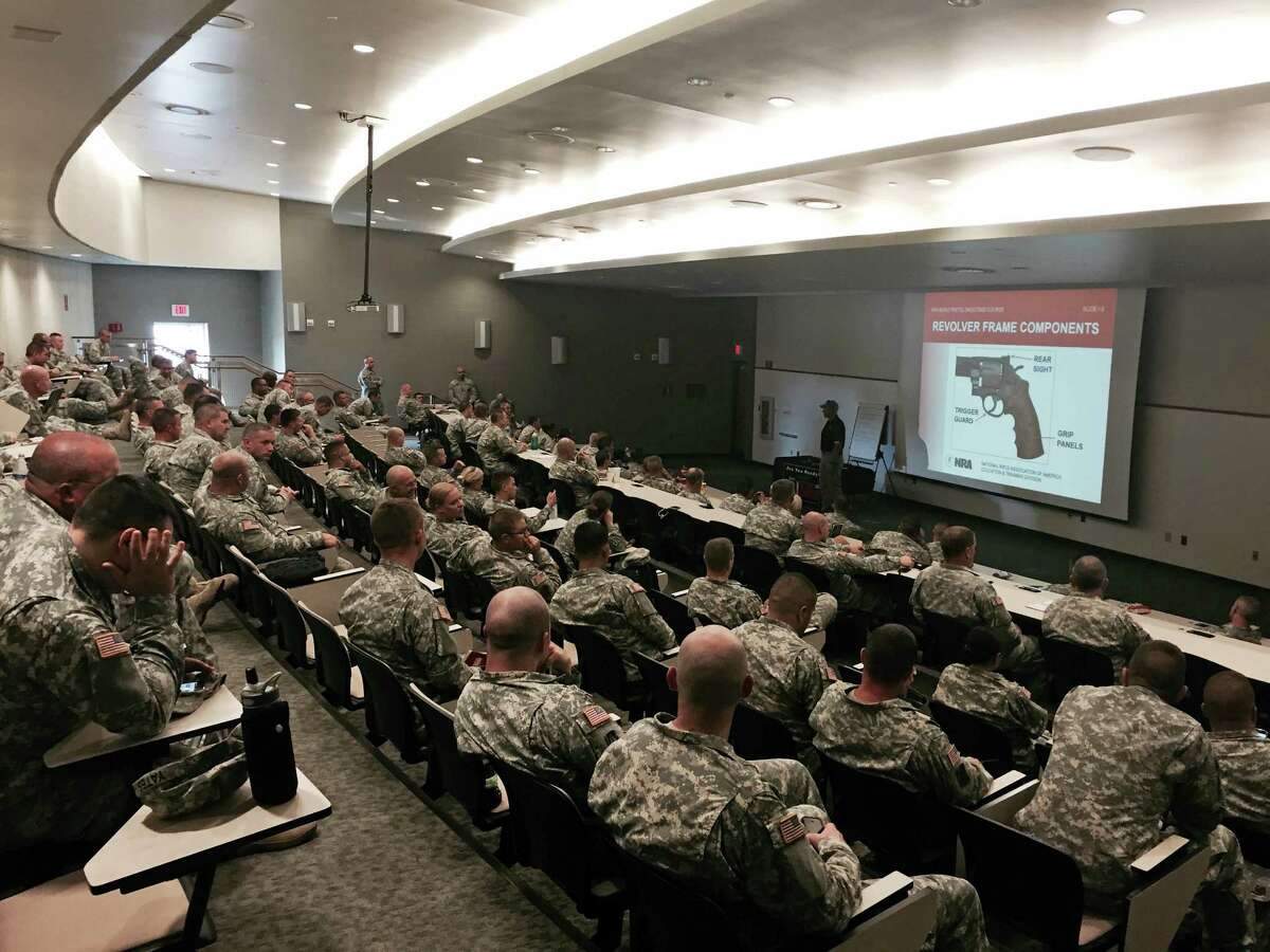 Members of the Indiana National Guard undergo National Rifle Association firearm training recently in the auditorium of the Johnson County Armory in Franklin, Ind.