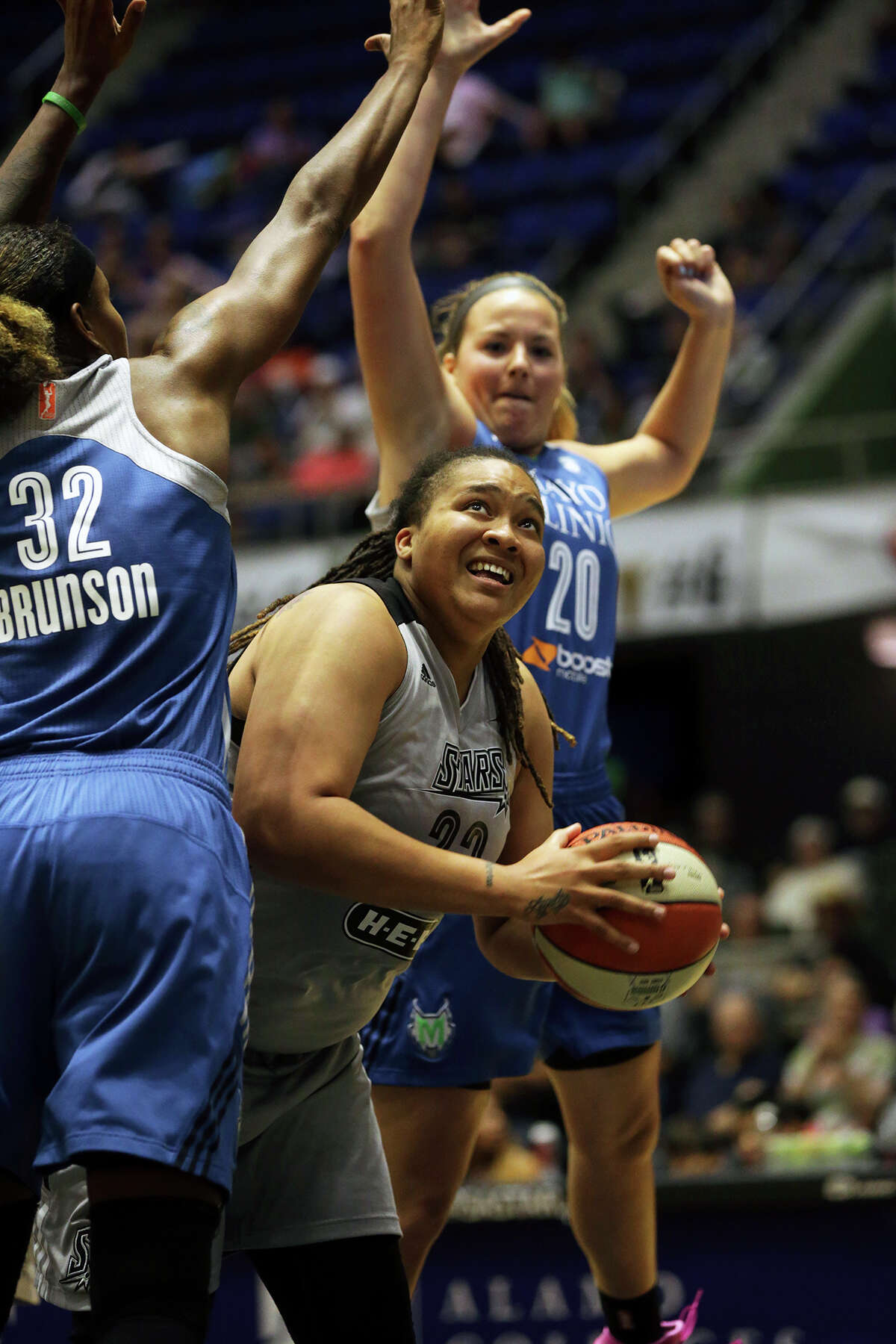 Danielle Adams challenges Rebekkah Brunson (32) and Tricia Liston under the boards as the Stars host the Minnesota Lynx at Freeman Coliseum on August 21, 2015.