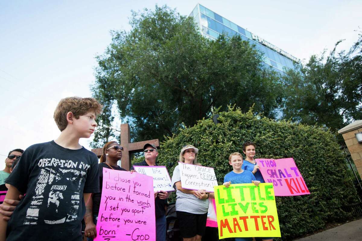 Several hundred people gather in front of Planned Parenthood in Houston to protests the abortions that take place in the clinic in light of the secrete videos released targeting Planned Parenthood. The videos intend to show that Panned Parenthood profits from sales of fetal body parts for medical research, but the organization denies the allegations. Saturday, Aug. 22, 2015, in Houston.