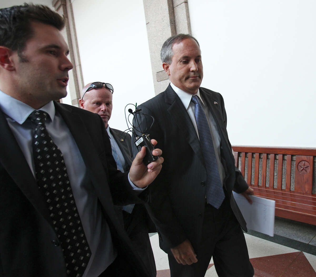 Texas Attorney General Ken Paxton walks the halls of the capitol after he appears before the Senate Health and Human Services Committee on July 29, 2015. Paxton has come under fire for his roll in a probate case which has raised significant questions about his ethical conduct as a court-appointed attorney ad litem — a role in which he was required to protect their interests as if he were their hired lawyer under both Texas case law and ethics rules.