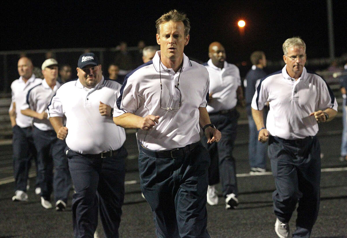 Ranger head coach Larry Hill brings his staff onto the field as Canyon hosts Smithson Valley at Canyon High School Stadium in New Braunfels on October 25, 2013.