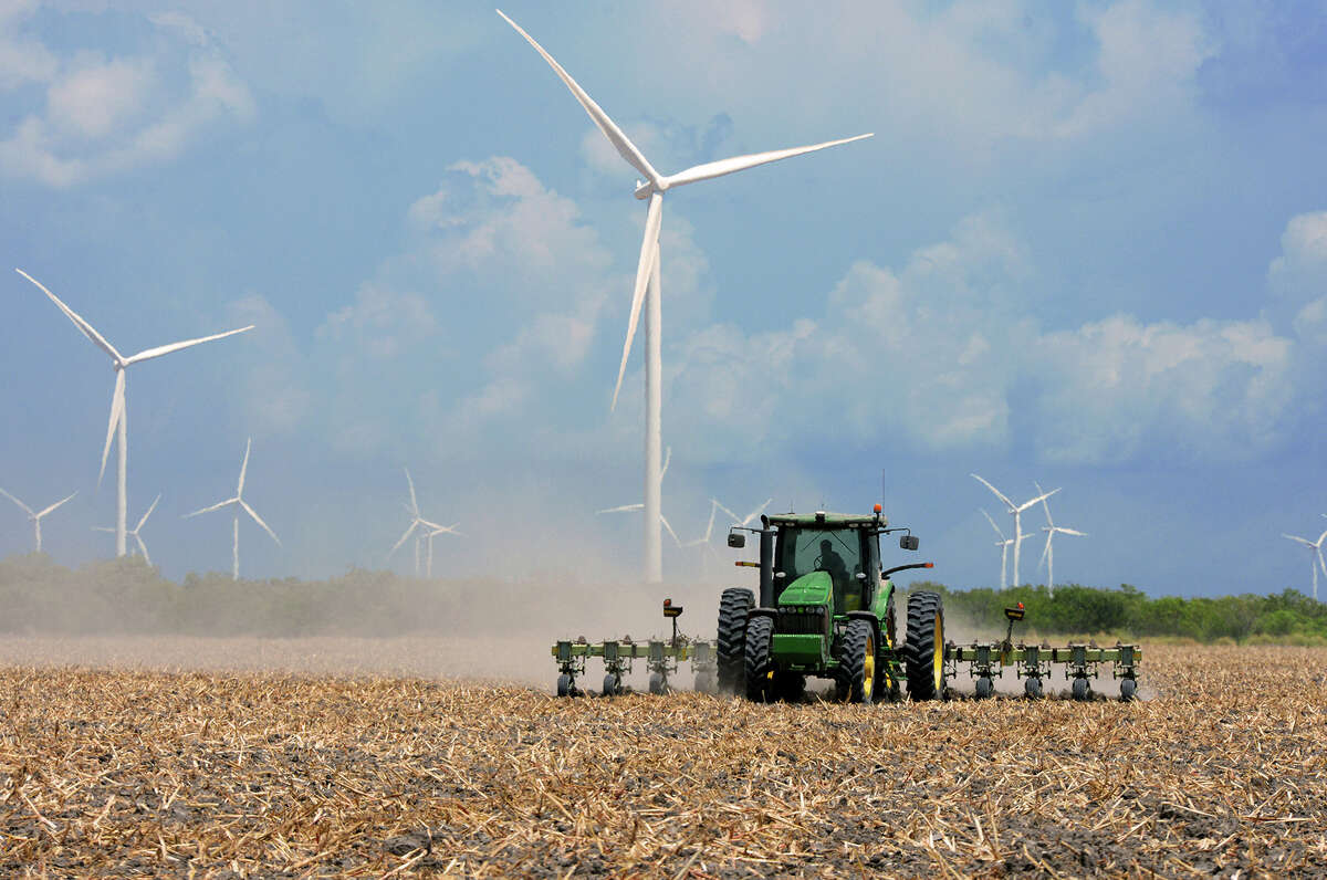 A farmer plows his recently harvested field as the hot summer sun beats down on Monday, Aug. 17, 2015 in the agricultural area north of Rio Hondo, Texas. Following the harvest, fields are required to be cut down to prevent boll weevil infestations in the fall. (Jason Hoekema/Valley Morning Star via AP)