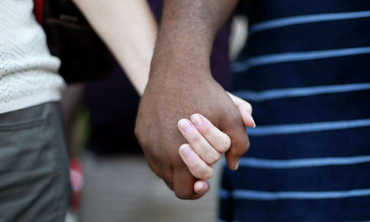 Participants hold hands at a prayer vigil in Detroit last August for Michael Brown, who was killed in Ferguson, Missouri.