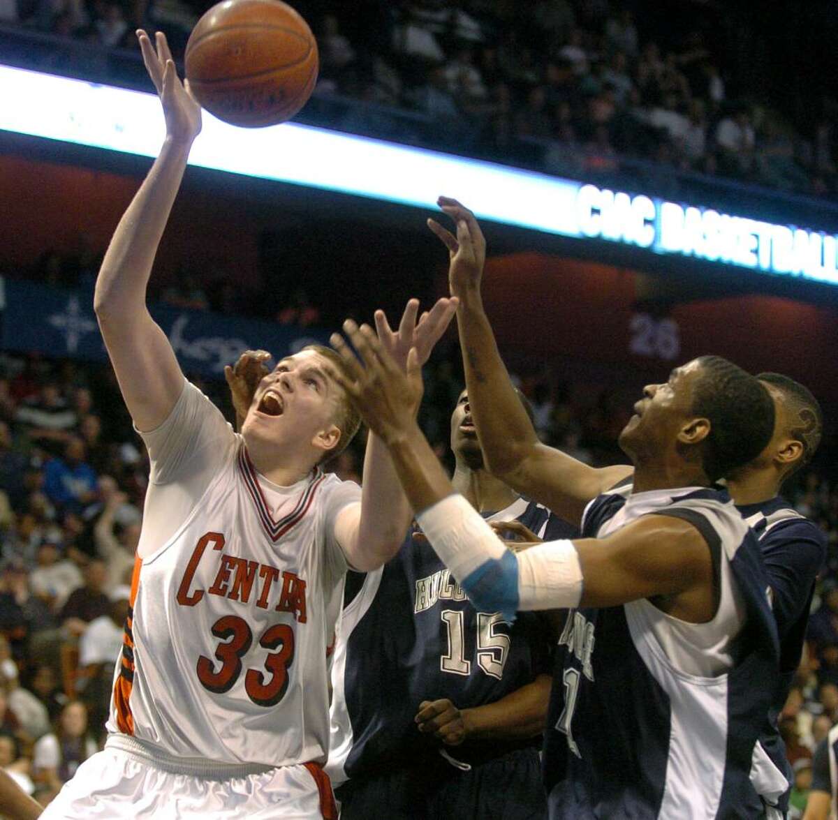 Central's #33 Andrew Victoria struggles to capture a rebound, during Class L state championship action against Hillhouse at Mohegan Sun Arena in Uncasville, Conn. on Saturday Mar. 20, 2010.