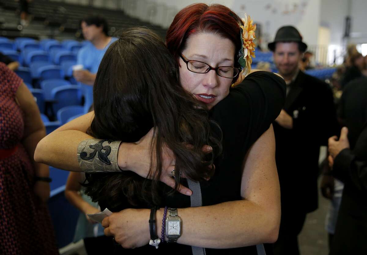 Laura Jordan gets a hug during a celebration of life ceremony for her daughter Madyson Middleton in Santa Cruz, California, on Sunday, Aug. 23, 2015.