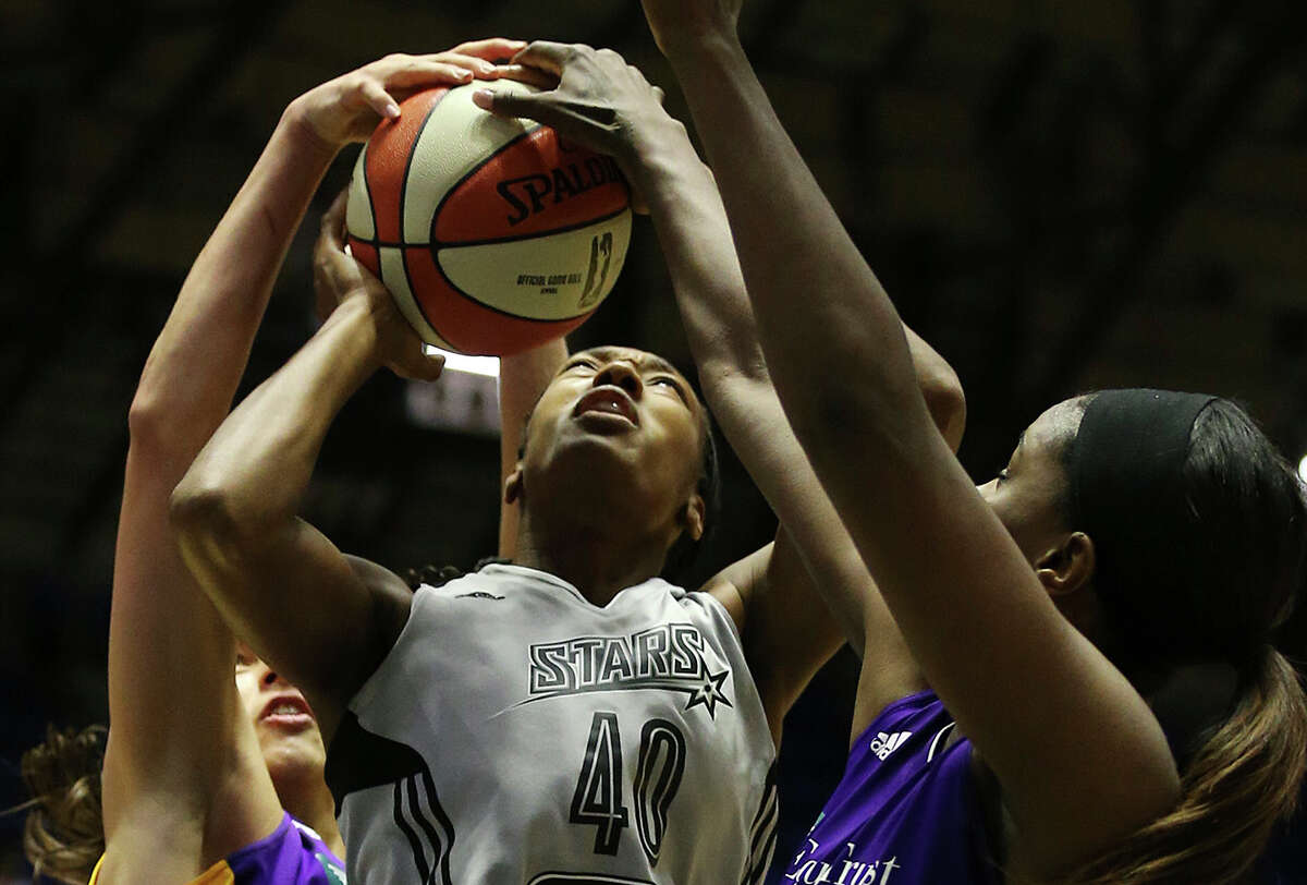 The Stars’ Kayla Alexander is surrounded by Sparks during the second half of a blowout loss at Freeman Coliseum.