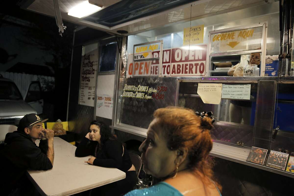 Maggie Ponce and her husband Luis Ponce wait for their food as Sara Garcia waits to order, right, in Richmond, Calif., on Saturday, August 22, 2015.