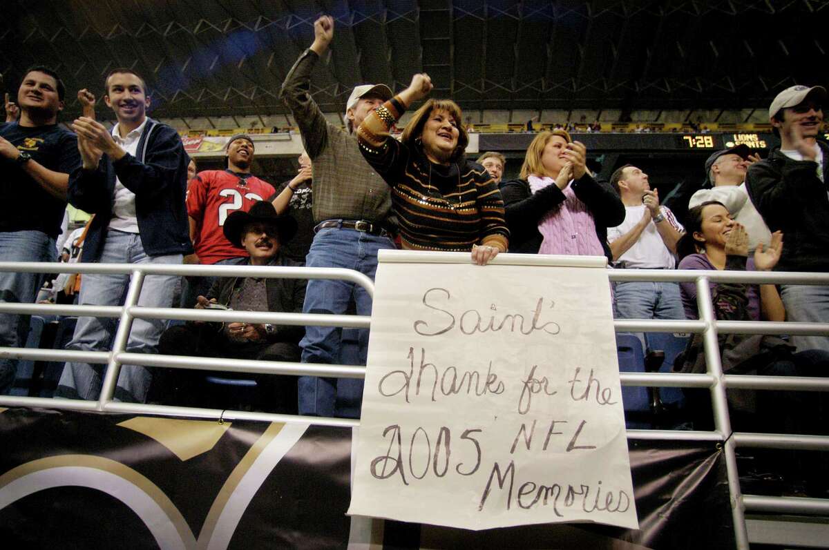 San Antonio native Delores Gonzalez, behind sign, cheers on the New Orleans Saints with other fans during a game between the New Orleans Saints and the Detroit Lions at the Alamodome, Dec. 24, 2005. The Saints were defeated 13-12. SPECIAL TO THE EXPRESS-NEWS/ERIC KAYNE